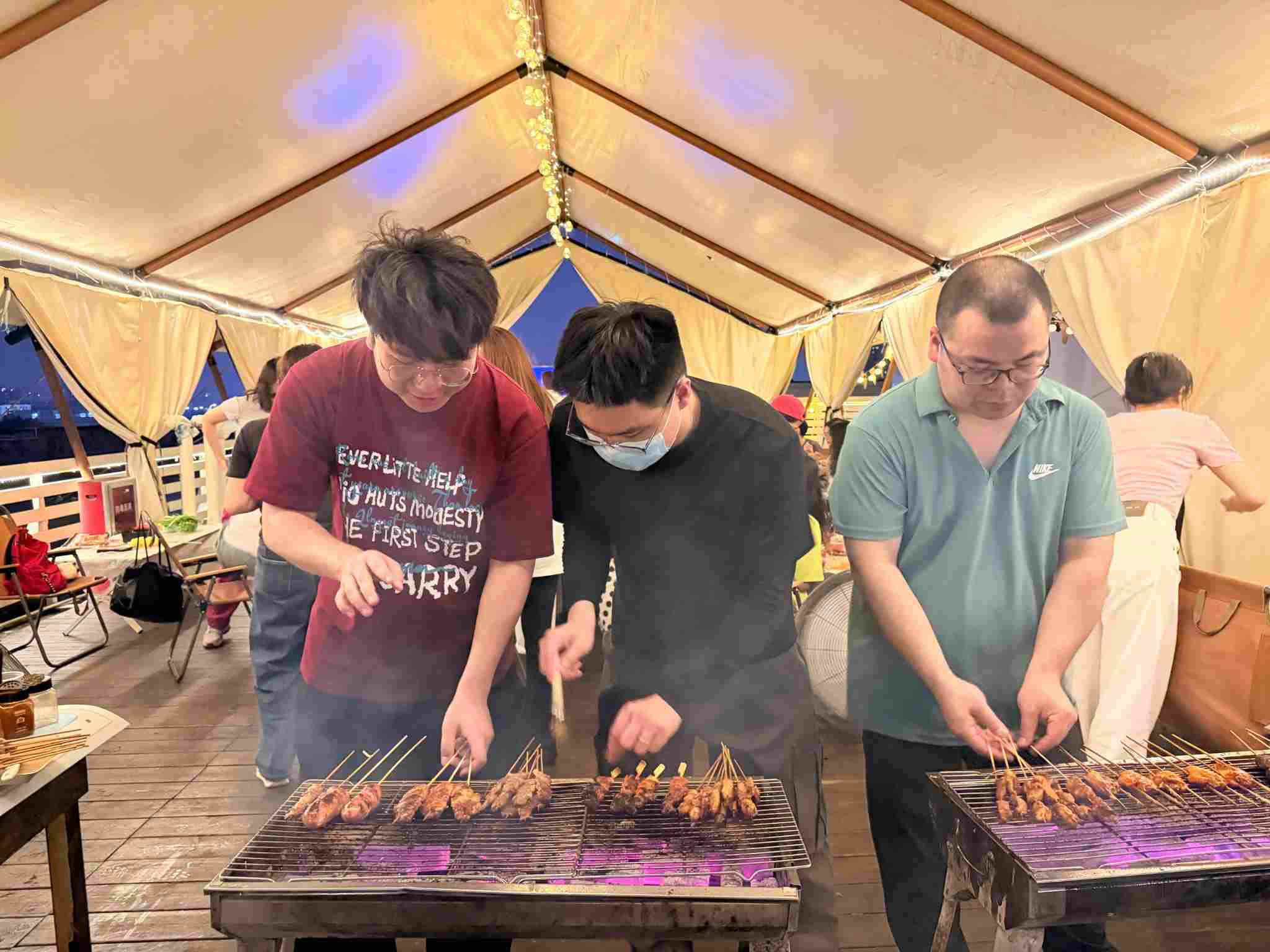 Beneox colleagues preparing food during an outdoor team event