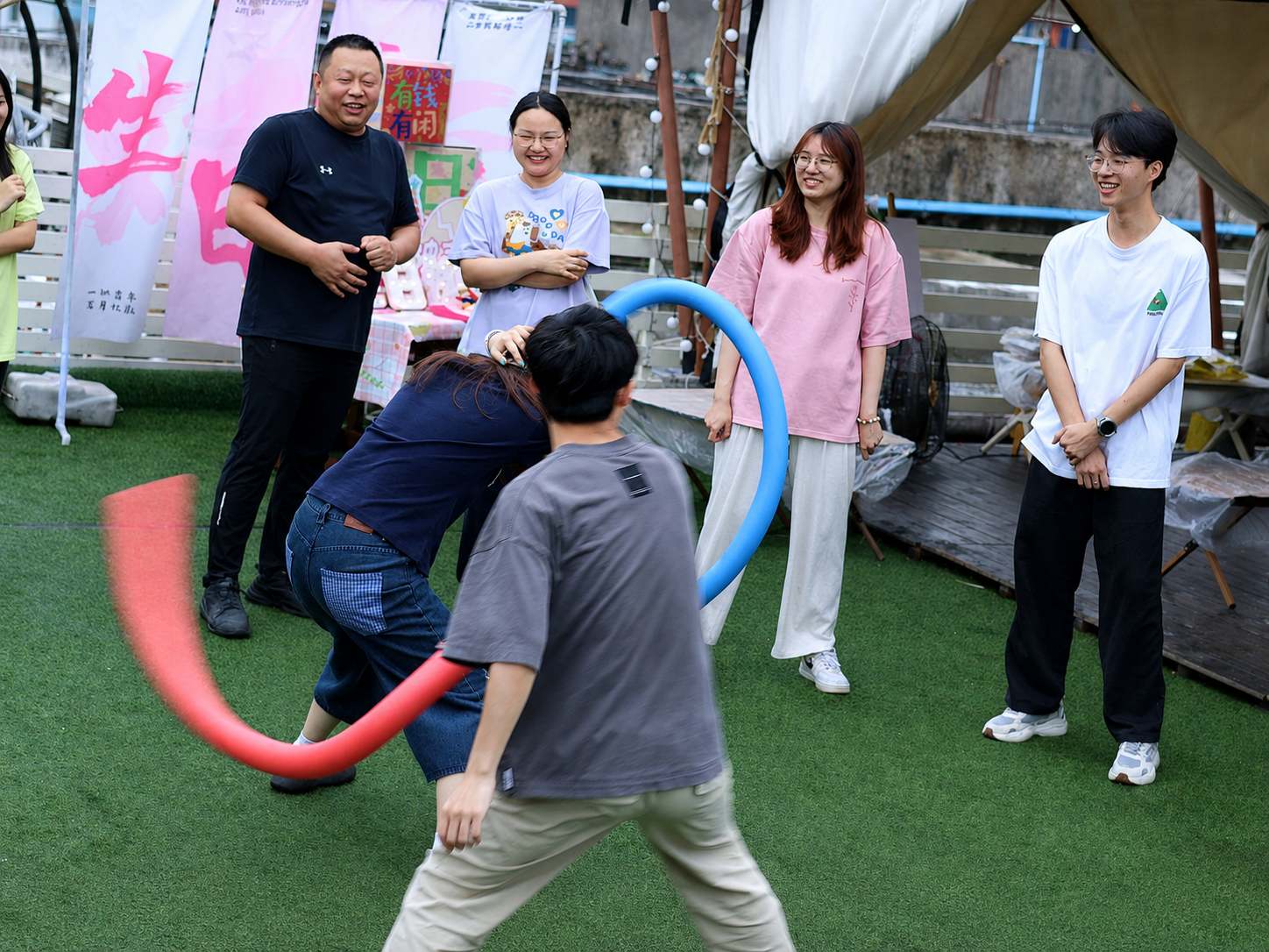 Beneox colleagues playing an outdoor ring team game