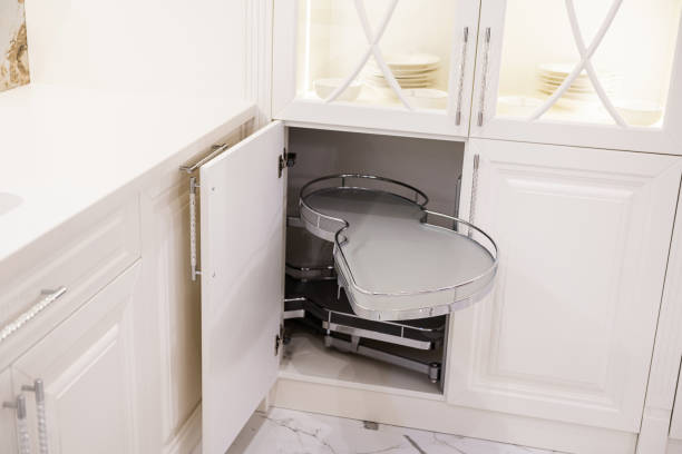 metal pull out shelf in a white kitchen made of natural wood